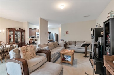 Living area with light colored carpet