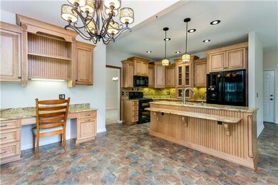 Eat-in area overlooking backyard with beautiful lighting and built-in desk area!!