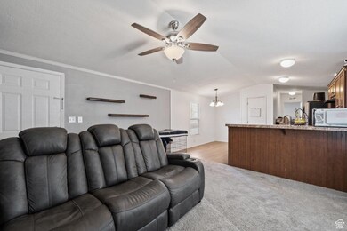 Step inside to a spacious open-concept living area featuring plush carpet, updated lighting, and neutral tones that complement any style. The perfect place to kick back and relax.