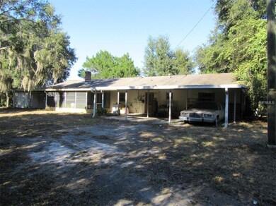 Rear of the Home with Covered Car Port and Screene