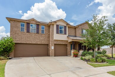Expanded Front Drive with ample parking, including a three-car garage and additional spaces for guests. Walkway with gentle curves and blooming flowers welcome you to the Front Entrance.