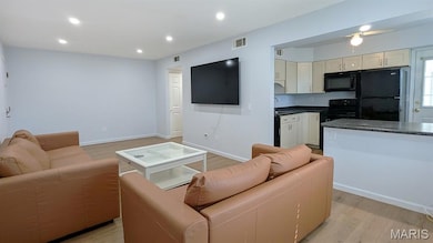 Living room featuring light wood finished floors and recessed lighting