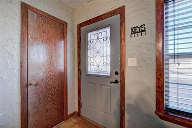 Doorway with light wood-style floors, a wealth of 