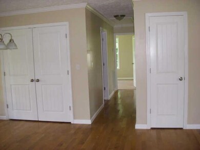 looking down the hall, w/d hook-up's behind double doors