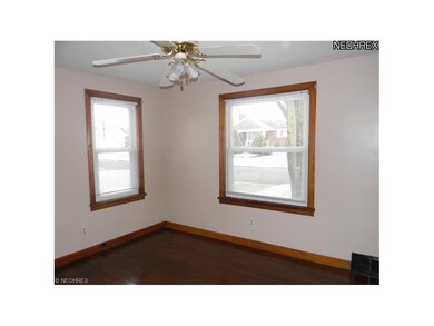 Front bedroom wih hardwood floor.
