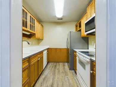 Kitchen featuring light wood-style flooring, a si
