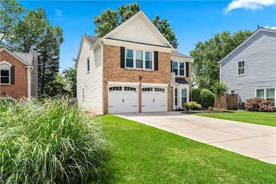 Traditional home featuring brick siding, concrete driveway, and an attached garage