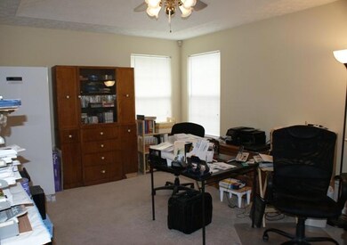 The masterbedroom features a trey ceiling, private bath and walk-in closet. It is currently being used as an office.