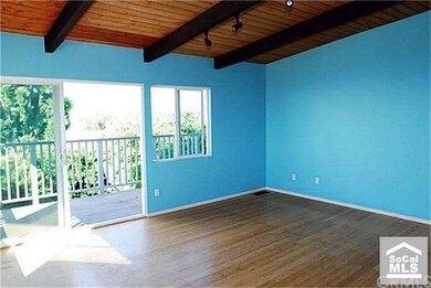 View of living room with beamed ceiling.