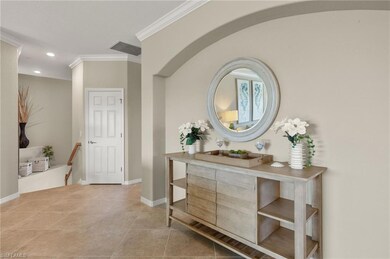 Living room with crown molding and tile floors