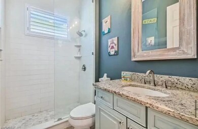 Full bath with a shower stall and vanity