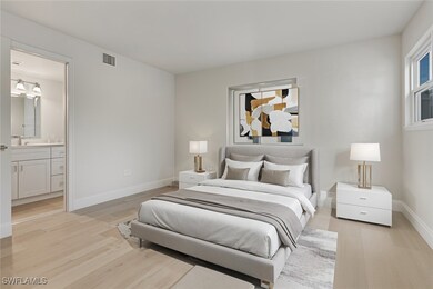 Virtually Staged Bedroom with light wood-style flooring and ensuite bathroom