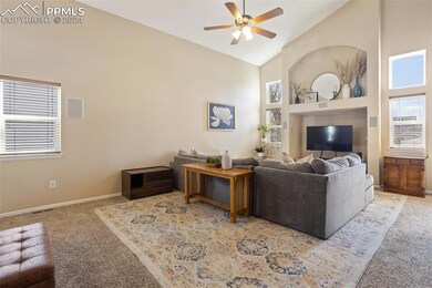 Carpeted living room featuring high vaulted ceilin