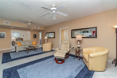 Living room featuring ceiling fan and light tile patterned flooring