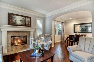 Stunning Hardwood Floors, Crown Molding and Plantation Shutters impress you upon entry. A Spacious Living Room Boasts a Cheery Fireplace, great for a quiet read or meeting with friends and opens to the dining room for relaxed entertaining.
