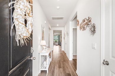 Corridor featuring wood finished floors