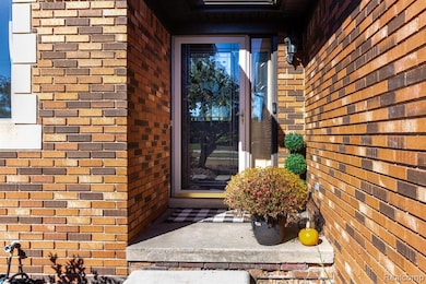 Property entrance featuring brick siding