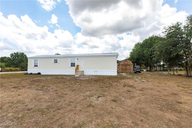 Rear view of property with entry steps and a stora
