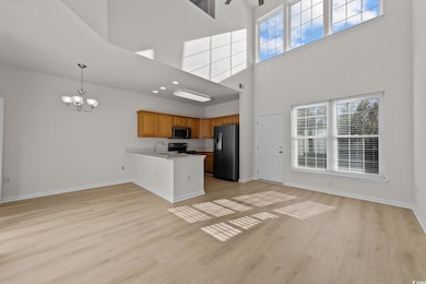 Kitchen featuring kitchen peninsula, appliances wi