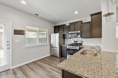 Kitchen with stainless steel appliances, a sink, 