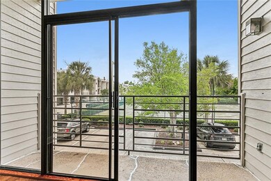 Living room view of private balcony and tennis cou