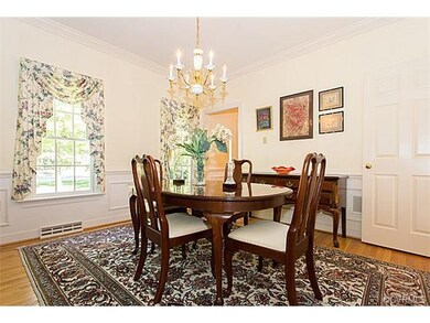 Spacious dining room with crown molding, chair rai
