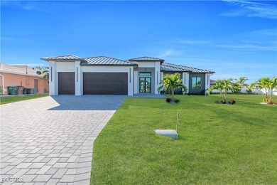 Prairie-style house featuring a standing seam roof, a metal roof, and decorative driveway