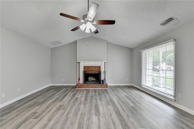 Unfurnished living room featuring a textured ceili