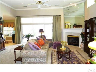 Great room has plant ledges, gas fireplace, and triple sliding doors to screened porch, great for letting in fresh air on nice days.