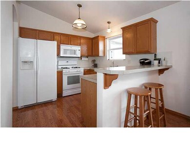 Fully applianced kitchen with eating bar open to d