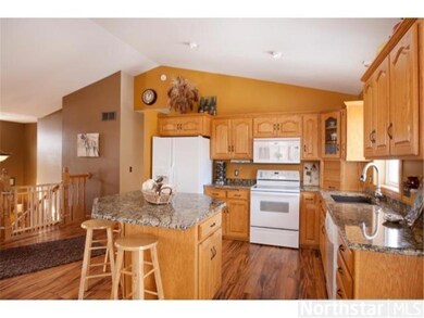 The kitchen boasts laminate flooring and raised oa