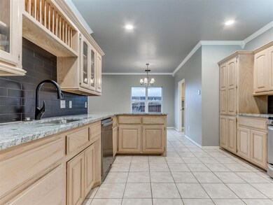 Kitchen with tasteful backsplash, crown molding, l