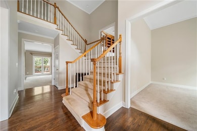 Stairs featuring wood finished floors and ornament