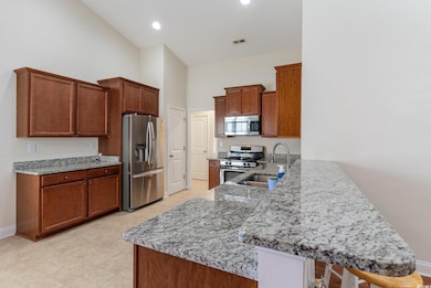 Kitchen with stainless steel appliances, light sto