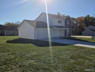 View of side of home featuring a lawn, driveway, and a garage
