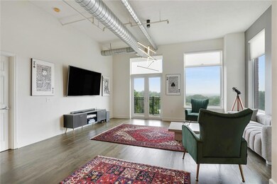 Living area featuring wood finished floors and a high ceiling