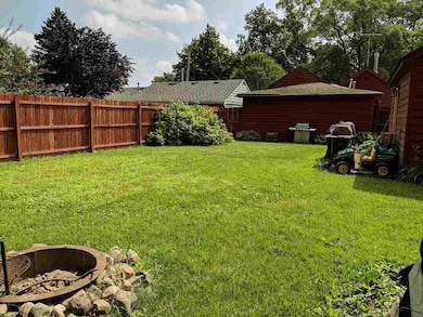 Fenced backyard with fire pit.