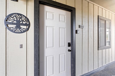 Property entrance featuring board and batten siding