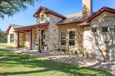 View of front of property with stone siding, roof
