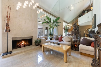 Living room with a premium fireplace, high vaulted
