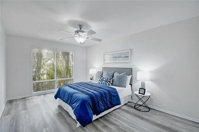 Bedroom with baseboards, ceiling fan, and wood fi