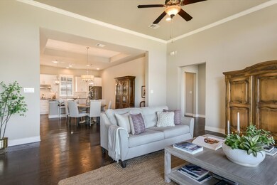 Living room with dark wood-style flooring, visibl