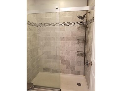 Remodeled master bath with new vanity, shower, and