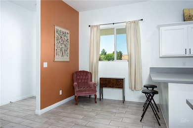 Sitting room with wood tiled floors and baseboards