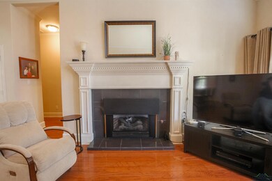 Living area with a fireplace and wood finished flo