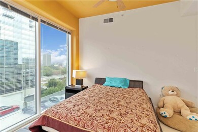 Bedroom featuring a city view, a ceiling fan, and access to outside