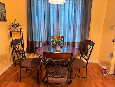 Dining area with wood finished floors and baseboards