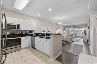 Kitchen with a peninsula, a sink, white cabinets, 