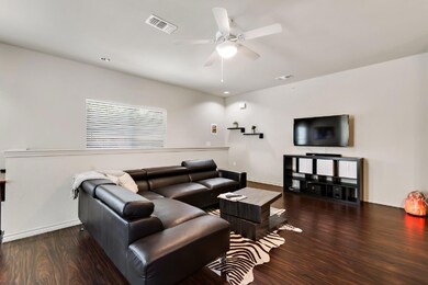 Living room with wood finished floors and a ceili