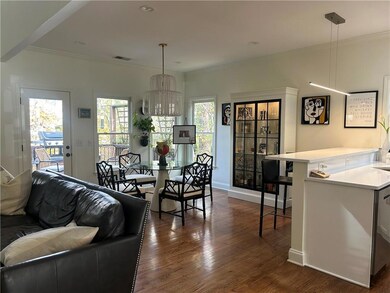 OPEN FLOOR PLAN WITH FAMILY ROOM AND KITCHEN LEADING TO BACK DECK